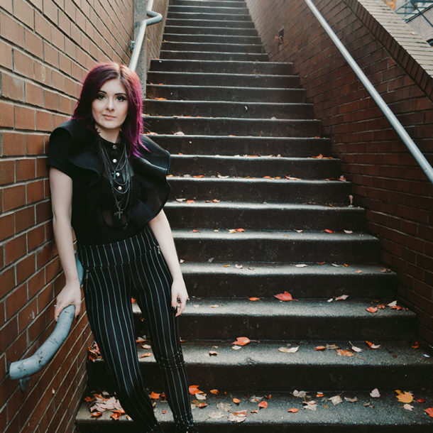 Photo of Bethany Stobbe standing in front of stairs